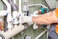 Engineer controlling the heating pipes at the boiler room. Royalty Free Stock Photo