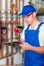 Engineer controlling the heating system Royalty Free Stock Photo