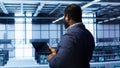 Engineer in data center fixing errors affecting server rows rigs