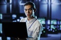 Engineer in data center with laptop