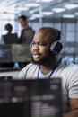 Engineer in data center listening music, optimizing IT infrastructure Royalty Free Stock Photo