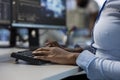Engineer in data center typing on keyboard, optimizing IT infrastructure