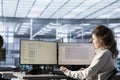 Woman in data center at PC checking servers bottlenecks leading to malfunctions Royalty Free Stock Photo