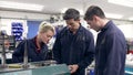 Engineer Demonstrating Machinery To Apprentices