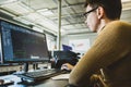 Engineer designer working on desktop computer in factory