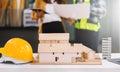 Engineer desk with object paper and tablet with blurry engineer teamwork hardworking to consults about their building project