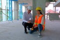 Engineer is discussing with his foreman in building site