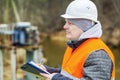 Engineer with documentation near power transformer Royalty Free Stock Photo