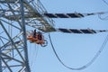 Engineer Electrician Workers On Lift Repairing Electricity Pylon Powerline