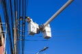 Engineer electricians repairing electricity power line at high place of electric pole Royalty Free Stock Photo