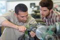 Engineer exerting effort to turn component on machine