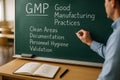 Engineer explaining GMP compliance fundamentals on chalkboard with focus on controlled documentation, validation processes, Royalty Free Stock Photo