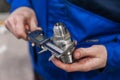 Close-up of the hand of a worker measuring a part from the mechanism of an accurate measuring instrument. Electronic caliper Royalty Free Stock Photo