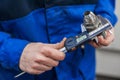 Close-up of the hand of a worker measuring a part from the mechanism of an accurate measuring instrument. Electronic caliper Royalty Free Stock Photo