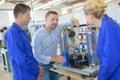 Engineer in factory with apprentices checking components Royalty Free Stock Photo