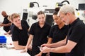 Engineer In Factory With Apprentices Checking Components Royalty Free Stock Photo