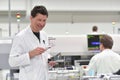 engineer in a factory for the production of electronic components checks the quality of an assembled board with the help of a