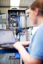 Female Engineer In Factory Using Laptop Computer