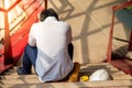 Engineer feeling stressed and tired while sitting at construction site Royalty Free Stock Photo