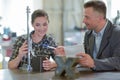 engineer and female apprentice working on machine in factory Royalty Free Stock Photo