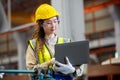 engineer female using laptop working in manufacturing factory. woman worker technician metalwork automated mechanical energy Royalty Free Stock Photo