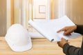 engineer finger point on paper plan blueprint in check building technician place construction site gypsum board wall interior