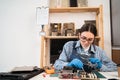 Engineer fixing broken computer motherboard using tweezers. Electronic repair shop, technology development Royalty Free Stock Photo