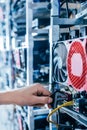 IT engineer fixing computer server on bitcoin and crypto currency mining farm Royalty Free Stock Photo