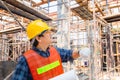 Engineer / foreman checking and planning project at construction site, Man holding blueprint with blurred background Royalty Free Stock Photo