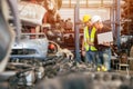 Engineer foreman manager working checking stock with young male staff worker