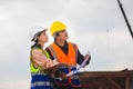 Engineer and foreman worker checking project at building construction site Royalty Free Stock Photo