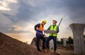 Engineer and foreman worker checking project at building site, Engineer and builders in hardhats discussing on construction site, Royalty Free Stock Photo