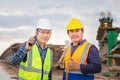 Engineer and foreman worker checking project at building site, Engineer and builders in hardhats discussing on construction site, Royalty Free Stock Photo