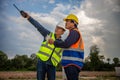 Engineer and foreman worker checking project at building site, Engineer and builders in hardhats discussing on construction site, Royalty Free Stock Photo