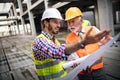 Engineer, foreman and worker discussing in building construction site