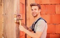 Engineer with hammer tool. Worker with hammer brick wall background. Building and construction. General maintenance and