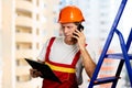 Engineer in hard hat talking on phone. Royalty Free Stock Photo