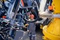 Engineer in hard hat and uniform is servicing hydraulic systems of mining equipment for descending into mine