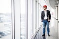 Engineer in hardhat with laptop computer, smiling at camera. Royalty Free Stock Photo