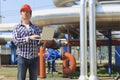 Engineer in hardhat with laptop