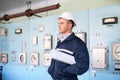 Engineer with helmet and blueprints at control room Royalty Free Stock Photo