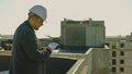 engineer on a high-rise rooftop inspecting the construction progress Royalty Free Stock Photo