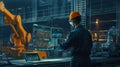An engineer in a high-tech manufacturing setting is programming or operating advanced automated machinery using a Royalty Free Stock Photo