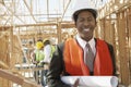 Engineer Holding Blueprint At Construction Site Royalty Free Stock Photo