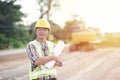 Engineer holding blueprint in construction site Royalty Free Stock Photo