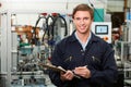 Engineer Holding Clipboard In Factory