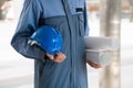Engineer holding hard hat and blueprint Royalty Free Stock Photo