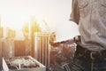 Engineer holding helmet for workers security on background of ne Royalty Free Stock Photo