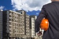 Engineer holding helmet for working at footing of building Royalty Free Stock Photo