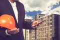 Engineer holding helmet for working at footing of building Royalty Free Stock Photo